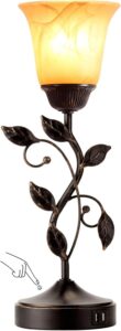 Bronze touch control bedside table lamp with amber glass shade, decorative leaf design and dual USB charging ports.