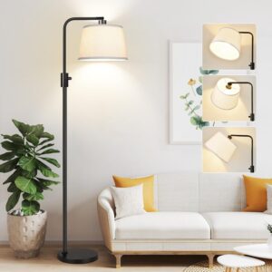 Modern black arc floor lamp with beige linen shade placed beside a white sofa in a cozy living room.