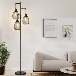 Matte black industrial tree floor lamp with three adjustable cage shades beside a modern sofa in a cozy living room