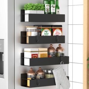 Black magnetic metal spice rack shelves attached to the side of a refrigerator holding spices, jars, and cooking essentials.