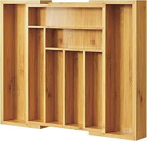 Expandable bamboo drawer organizer with adjustable compartments for cutlery, utensils, and kitchen tools.