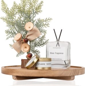 Round wooden decorative tray styled with candles and decorative accessories on a modern coffee table.