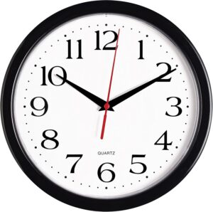 Modern black silent wall clock with large easy-to-read numbers mounted on a living room wall.