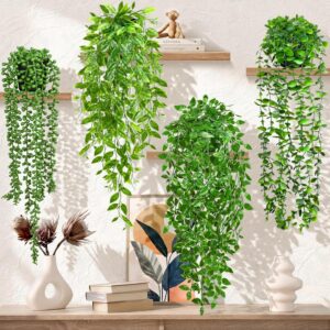 Set of four artificial hanging potted plants decorating floating wooden shelves in a modern living room.